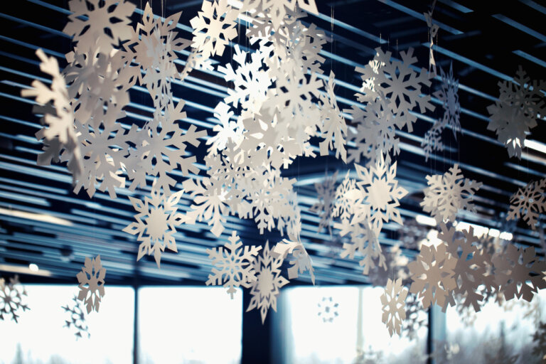 Decorative holiday snowflakes hang from ceiling in office of law firm