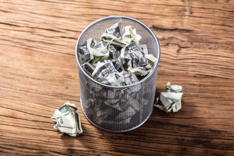 Dollar bills in trash can