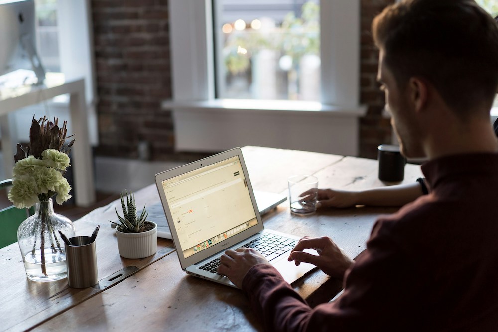 silhouette of man working on laptop computer