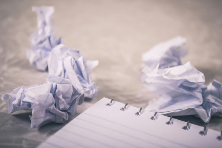 crumpled paper beside notepad