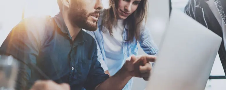 man and woman looking at a computer screen