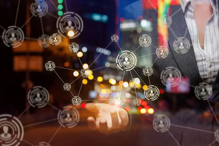 Woman shows the network in the background of the city.