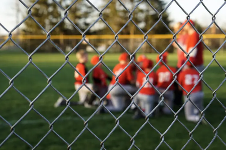 photo of little league team gathering on field