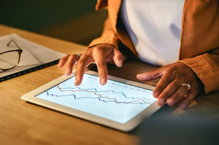 women reviewing marketing data on tablet