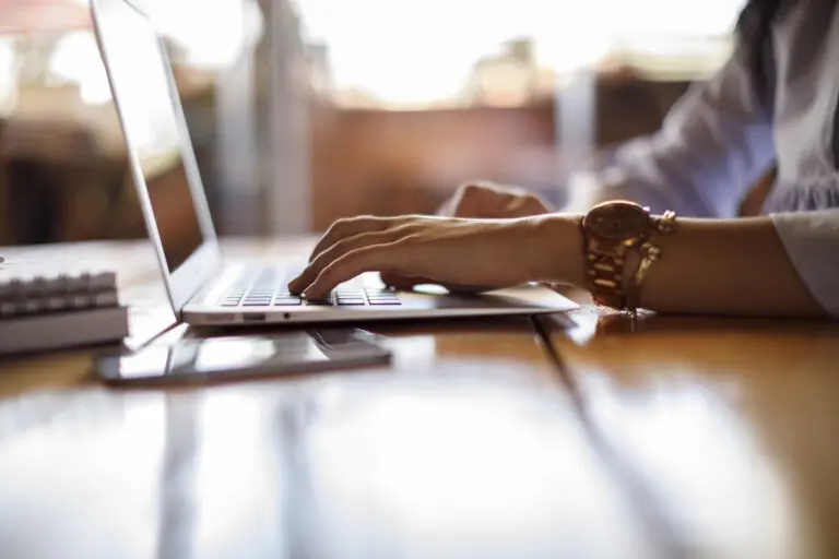 female attorney checking law firm's social media on laptop